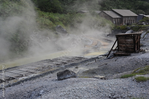 Sulphurous mountain valley with hot spring stream and steam at Tamagawa Onsen Hot spring in Senboku city, Akita prefecture, Tohoku region, northern Japan, Asia photo