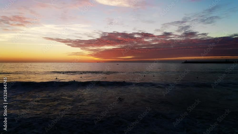 Surfers on Stunning beach Sunset. Sea Waves With Colorful Clouds in The Sky. Peaceful Place. Nature Landscape Aerial View. Travel Destination. Vacations Concept Surfers on Stunning beach Sunset. Sea Waves With Colorful Clouds in The Sky. Peaceful Place. Nature Landscape Aerial View. Travel Destination. Vacations Concept