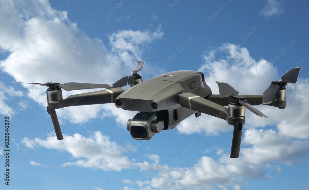A flying drone isolated on cloudy sky background A flying drone isolated on cloudy sky background