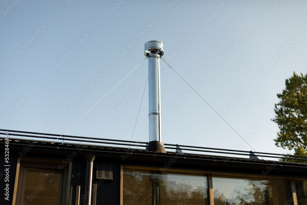 Pipe on roof of house. New fireplace chimney. Heating system in house. Pipe on roof of house. New fireplace chimney. Heating system in house.