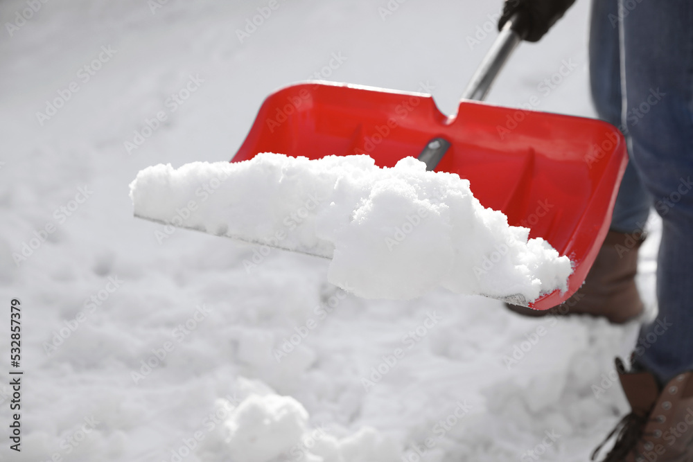Fototapeta premium Person shoveling snow outdoors on winter day, closeup