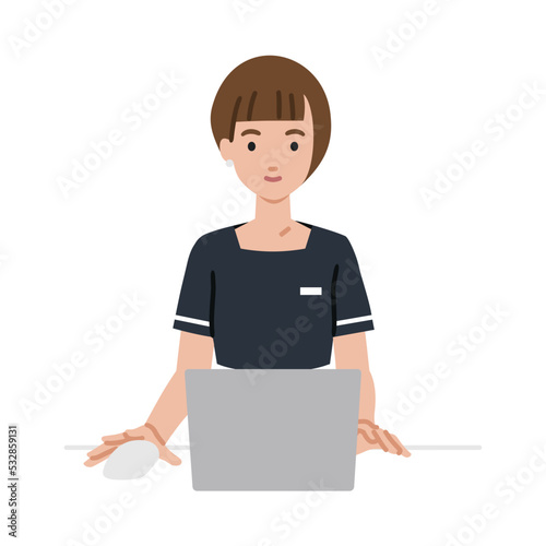デスクで座ってPCを使っているエステ店員・受付・接客係の女性