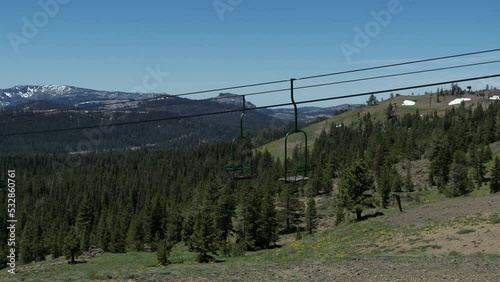 Close up aerial of two person chairlifts in summer in ski resort in Sierra Nevada mountains in California on Donner Pass
