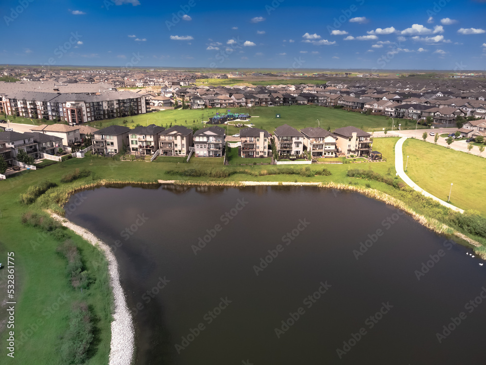 Lake with large expensive luxury homes build overlooking residential area on outskirts of city living.