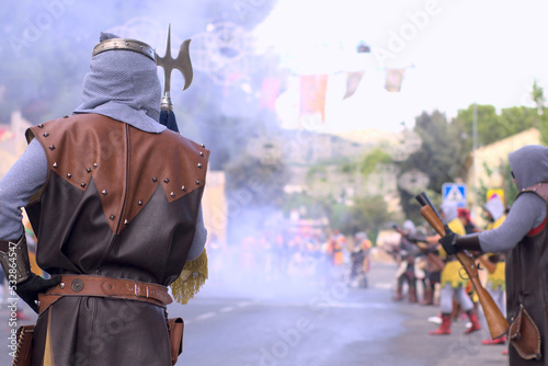 Moors and christians. Back turned christian sergeant in blunderbuss fight with copy space. Moros y cristianos typical fest in Spain. High quality photo photo