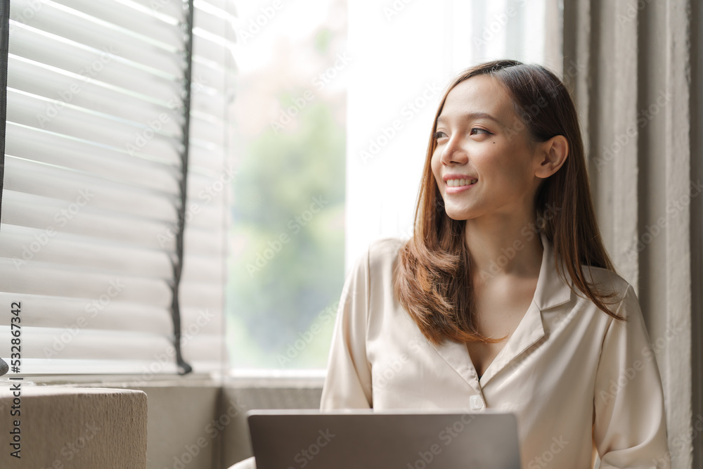 Young happy pretty asian woman using laptop at cafe. Young happy pretty asian woman using laptop at cafe.