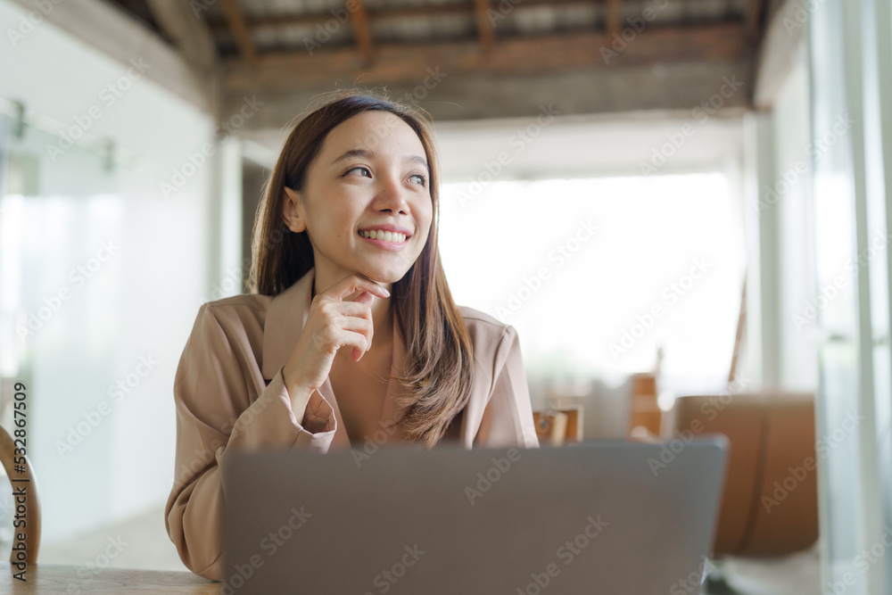 Young happy pretty asian woman using laptop at cafe. Young happy pretty asian woman using laptop at cafe.