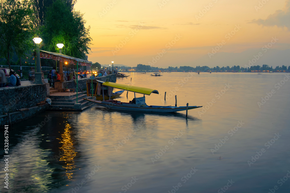 Srinagar, Jammu and Kashmir, India - 31st August 2014 : Sunset on Dal Lake, Srinagar. Houseboats floating on the lake in late afternoon.