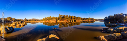 panoramic of lake at morning with blue sky and forest around in arareco lake, creel chihuahua  photo