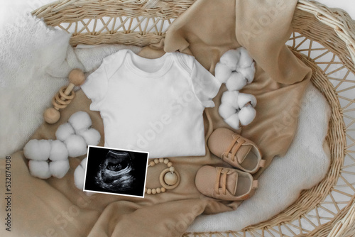 Mockup of white baby bodysuit shirt with basket, Social Media Baby Announcement .Background with blurred . Selective focus photo