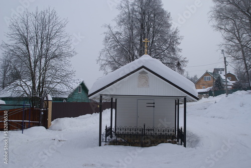Font with holy water in deep snow on the slope of the valley of the river Puddle in Maloyaroslavets © yorkzel