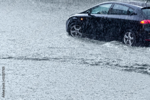 car rides on big water in the rain. driving in stormy weather.