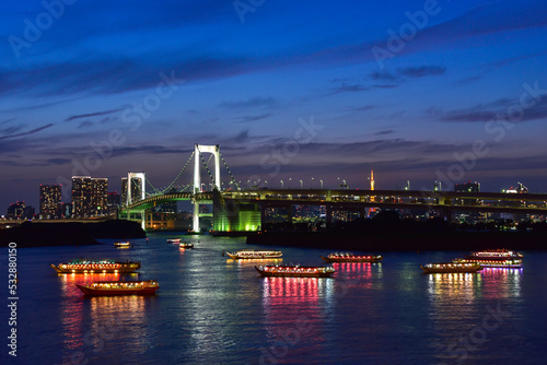Photography Rainbow bridge at night with yakatabune japanese party boats in tokyo