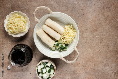 Pempek Lenjer Rebus is steamed fish cake from Palembang served with cuko photo