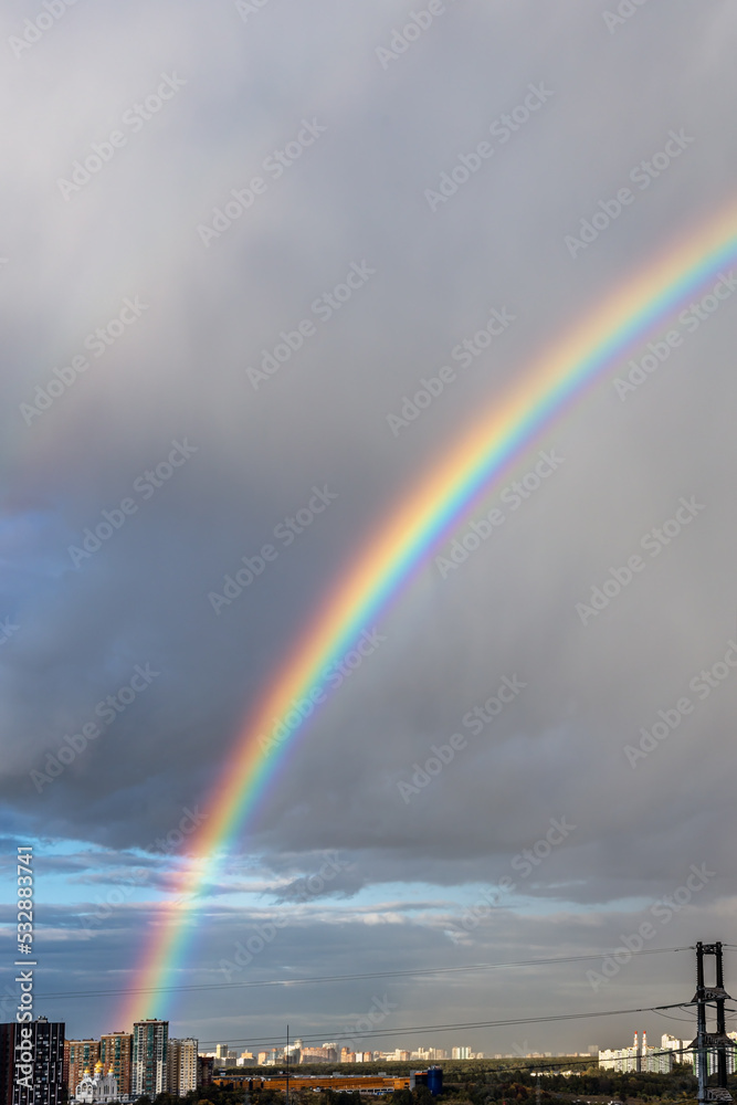 rainbow after a downpour over a big city