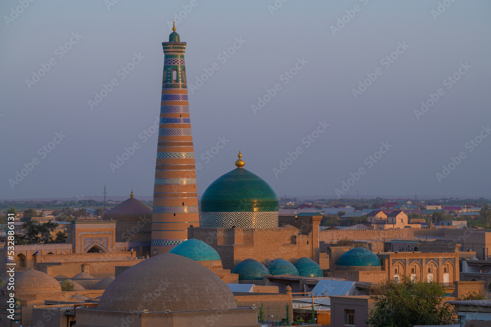 Naklejka premium Islam Khoja Minaret in the evening cityscape. Khiva, Uzbekistan