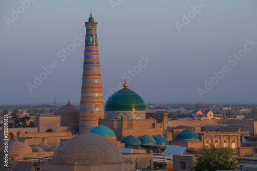 Islam Khoja Minaret in the evening cityscape. Khiva, Uzbekistan