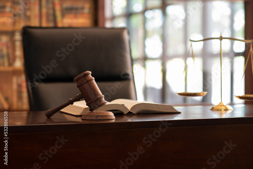 judge gavel, law books and scales of justice on desk in lawyer office. legal justice concept.