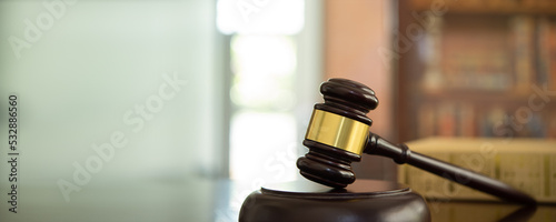 judge gavel, law books and scales of justice on desk in lawyer office. legal justice concept.	