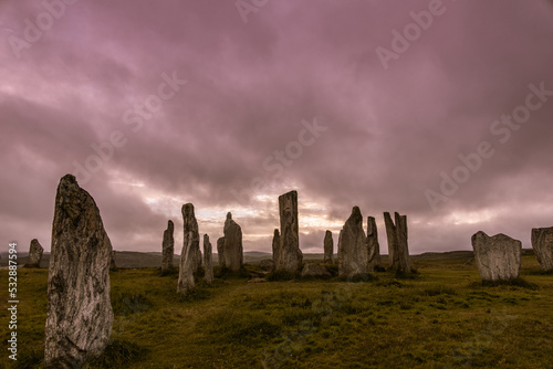 Ancient magic in the Calanais Standing Stones Circle, erected by neolithic men for worship. Celtic traditions in the outer hebrides of Scotland. Touristic attraction. photo
