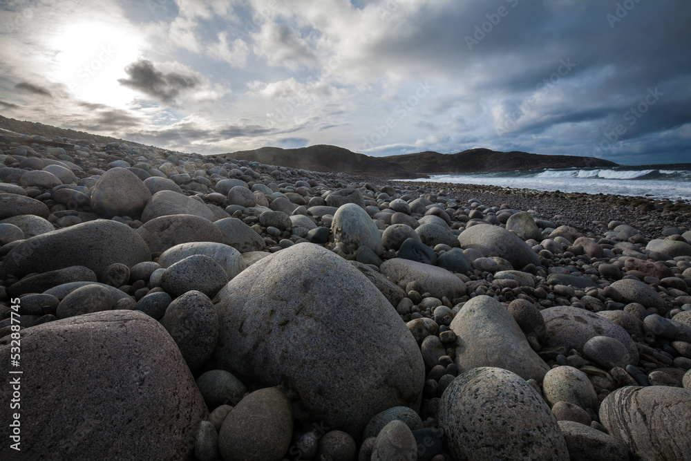 Arctic Ocean stone beach locate in Teriberka Village, Murmansk, Russia Arctic Ocean stone beach locate in Teriberka Village, Murmansk, Russia