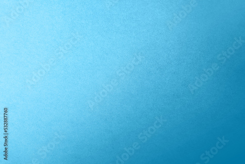 Soft dark cyan blue color gradation with light tone on corrugated fiberboard blank paper texture background with space