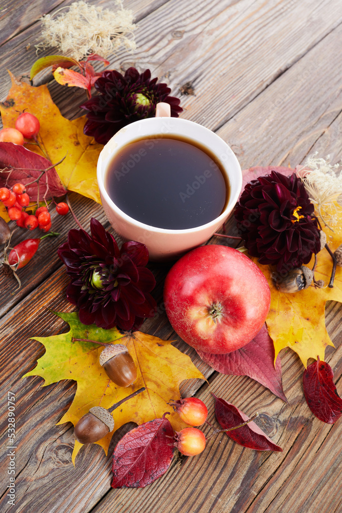 Autumn composition - coffee, maple leaves and flowers on wooden background. Seasonal autumn concept with drink. Autumn composition - coffee, maple leaves and flowers on wooden background. Seasonal autumn concept with drink.