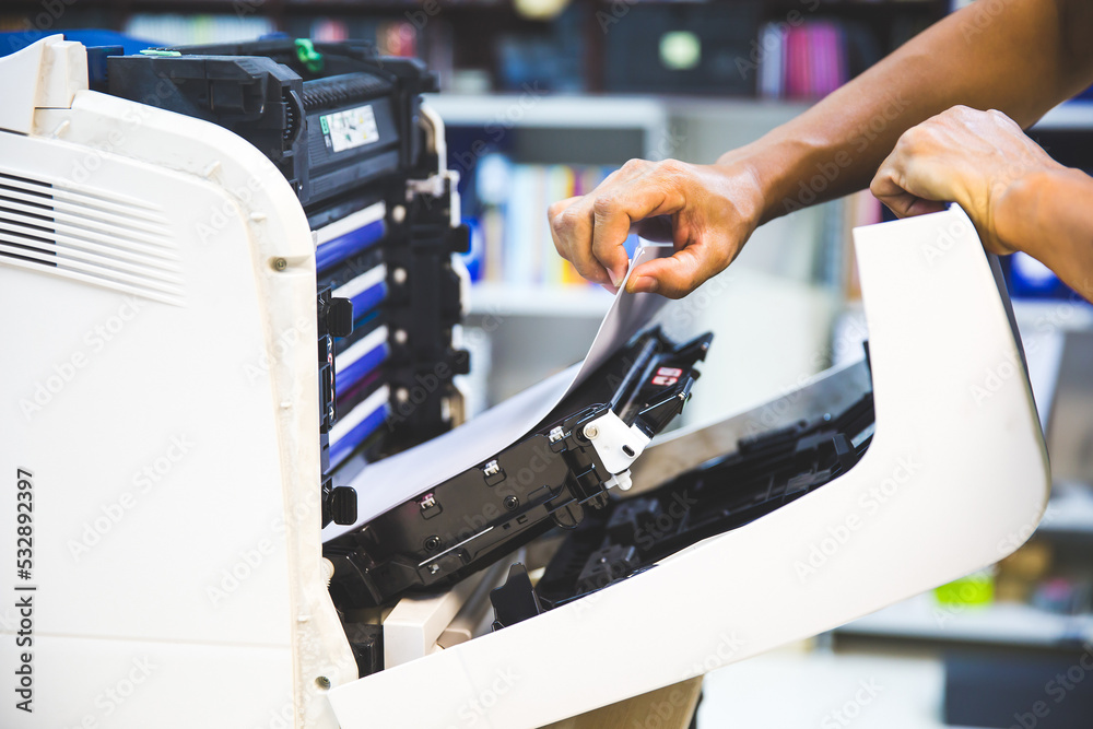 Technician hand open cover photocopier or photocopy to fix copier paper