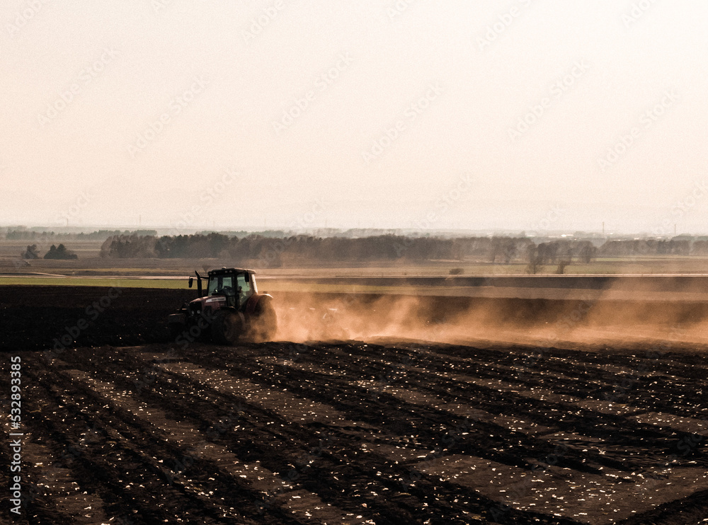 Fototapeta premium A tractor that raises dirt and runs