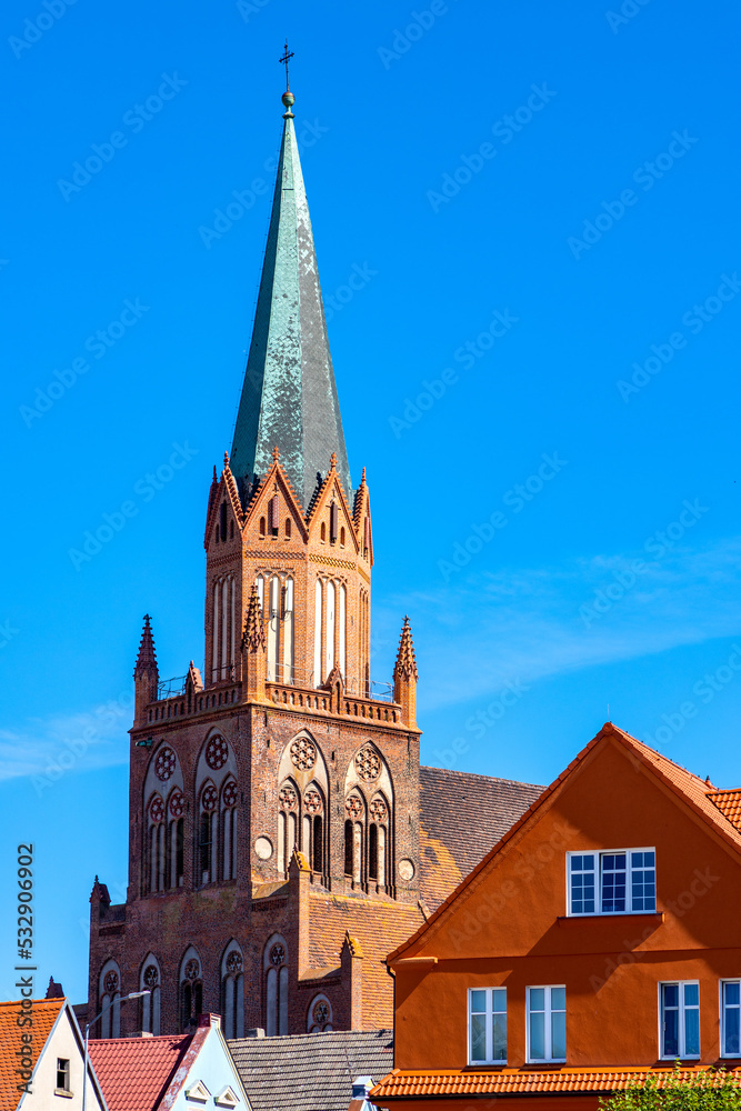 Historic Holy Mary gothic Kosciol Mariacki church in old town quarter of Trzebiatow in Poland