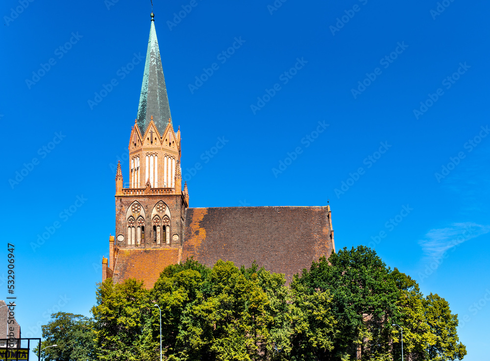 Obraz premium Historic Holy Mary gothic Kosciol Mariacki church in old town quarter of Trzebiatow in Poland