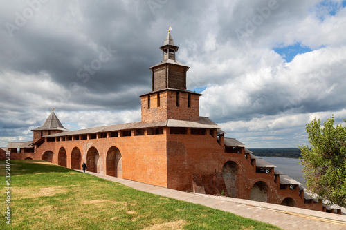 A fragment of the fortress wall of the Nizhny Novgorod Kremlin with the clock tower in the center and the North Tower in the distance. Nizhny Novgorod, Russia
