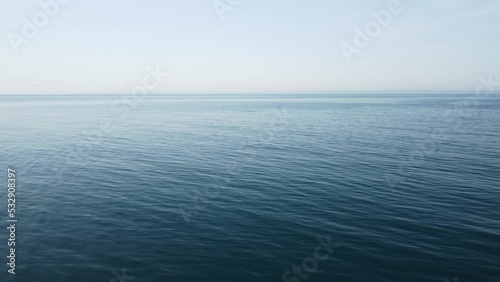 Wallpaper Mural Abstract aerial sea summer ocean sunset nature background. Seagulls are flying over calm water surface in motion blur with golden bokeh lights from sun. Holiday, vacation and recreational concept. Torontodigital.ca