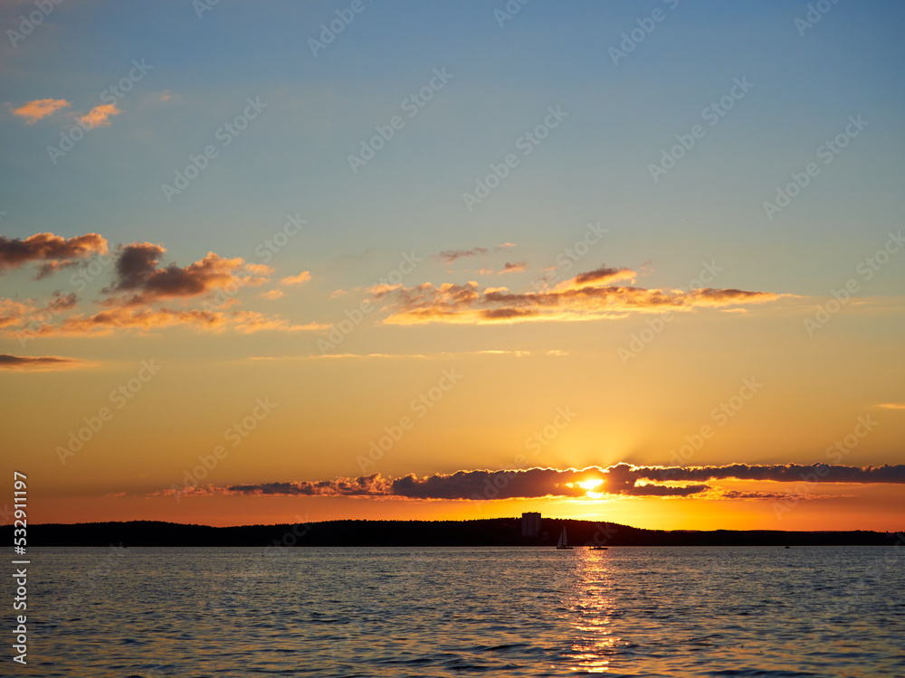 Beautiful sunset. Sunset over the water. The sun sets over a large lake.