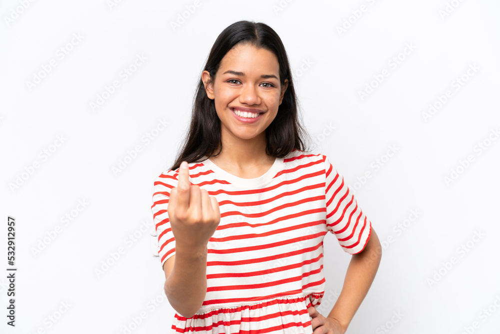 Young Colombian woman isolated on white background doing coming gesture Young Colombian woman isolated on white background doing coming gesture
