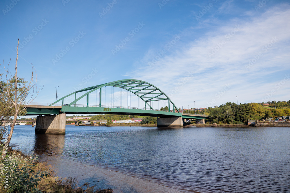 Blaydon England: 17th Sept 2022: View of Newcastle upon Tyne's Scotswood Bridge from the Tyne River in Blaydon. Sunny day with blue sky and light clouds Blaydon England: 17th Sept 2022: View of Newcastle upon Tyne's Scotswood Bridge from the Tyne River in Blaydon. Sunny day with blue sky and light clouds