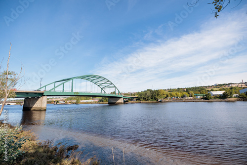 Blaydon England: 17th Sept 2022: View of Newcastle upon Tyne's Scotswood Bridge from the Tyne River in Blaydon. Sunny day with blue sky and light clouds photo