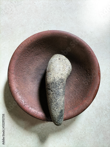 a traditional stone crusher or grinder called a 'coet' or 'cobek' photo