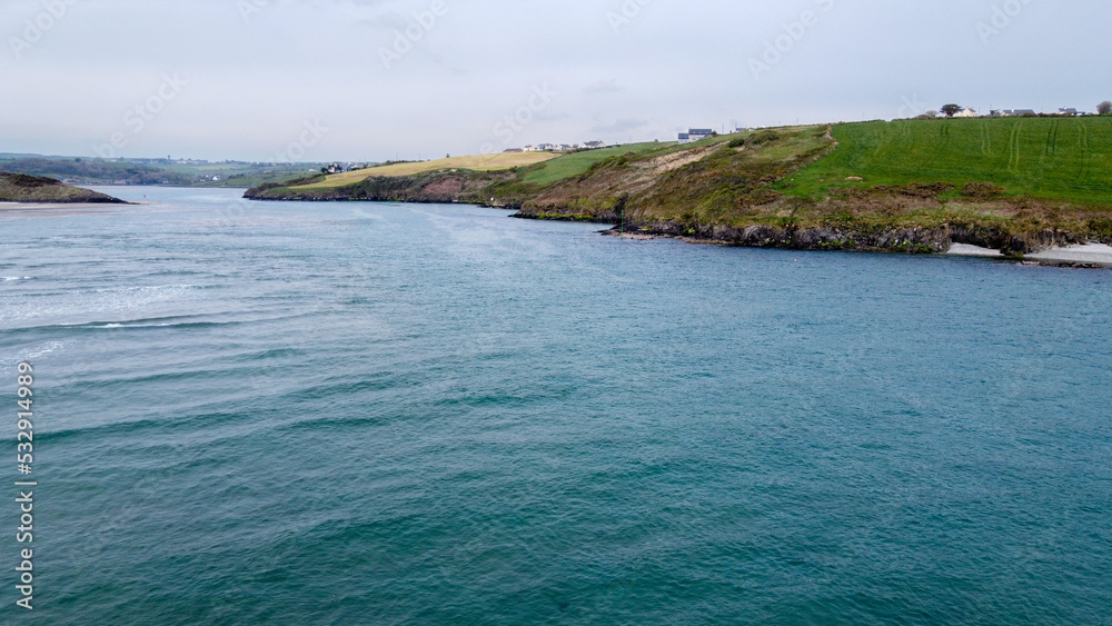 Beautiful turquoise sea water. Clonakilty Bay, the southern coast of Ireland. Seaside landscape on a cloudy day. Nature of Northern Europe.
