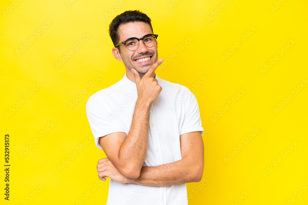 Young handsome man over isolated yellow background happy and smiling Young handsome man over isolated yellow background happy and smiling