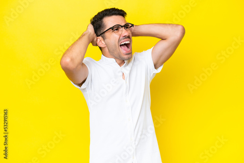 Young handsome man over isolated yellow background stressed overwhelmed