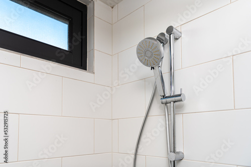 Clean shower head in modern bathroom.