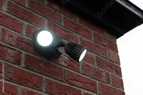 A dual head flood light mounted on the wall.