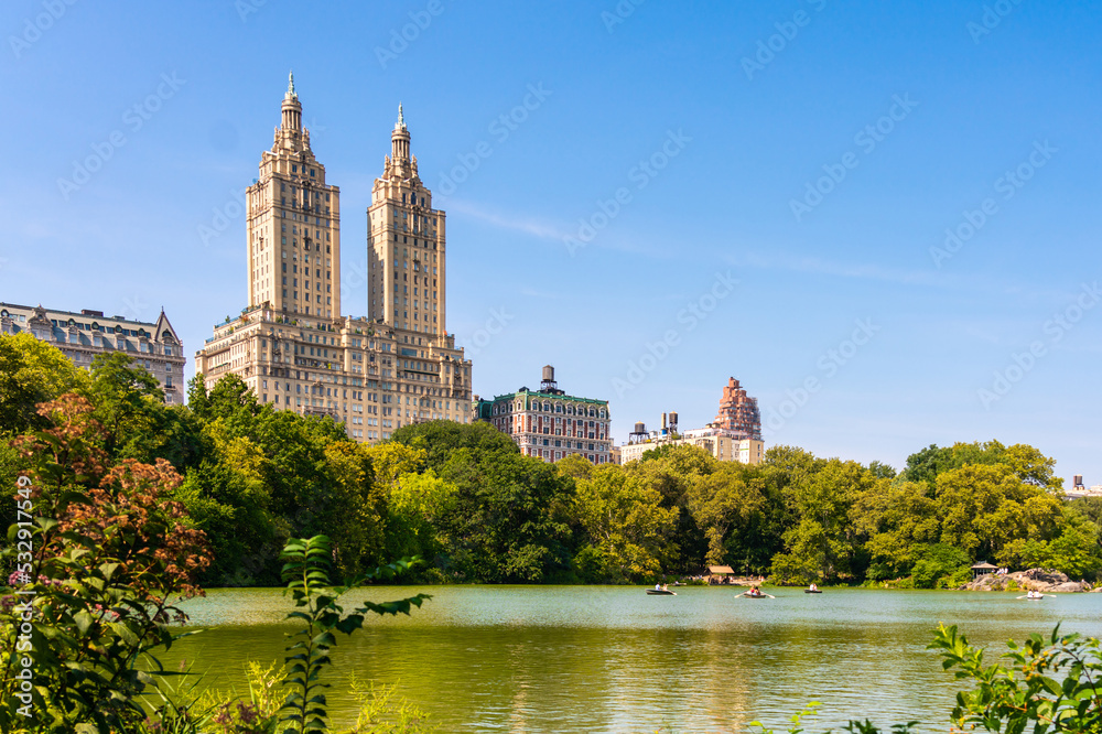 Skyline panorama with Eldorado building and reservoir with boats in Central Park in midtown Manhattan in New York City Skyline panorama with Eldorado building and reservoir with boats in Central Park in midtown Manhattan in New York City