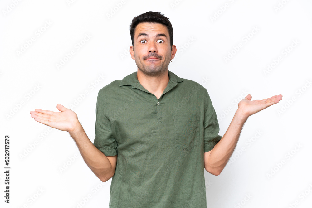 Young handsome man over isolated white background having doubts while raising hands Young handsome man over isolated white background having doubts while raising hands