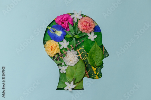 Papercut head with green leaves and flowers. Mental health, wellness, self care, psychology, green thinking, happy life, ecology concept