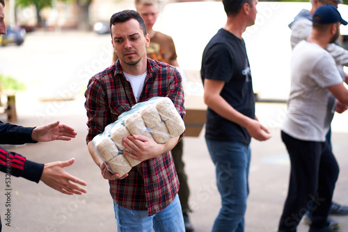Ukrainian volunteers unloading boxes with humanitarian aid