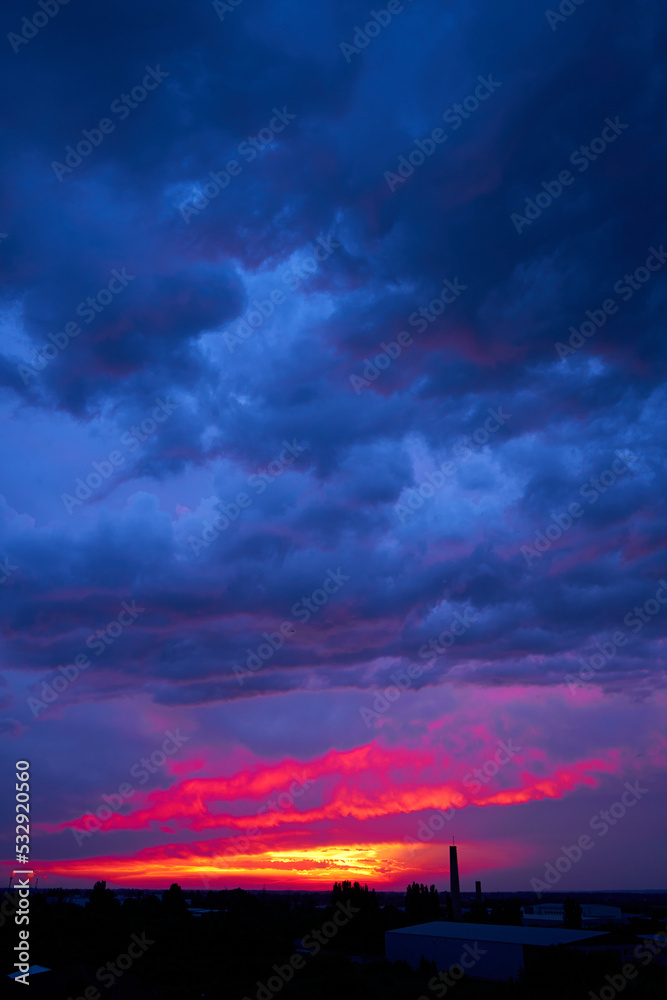 Fiery summer sunset landscape. Orange sun and dark blue sky Fiery summer sunset landscape. Orange sun and dark blue sky
