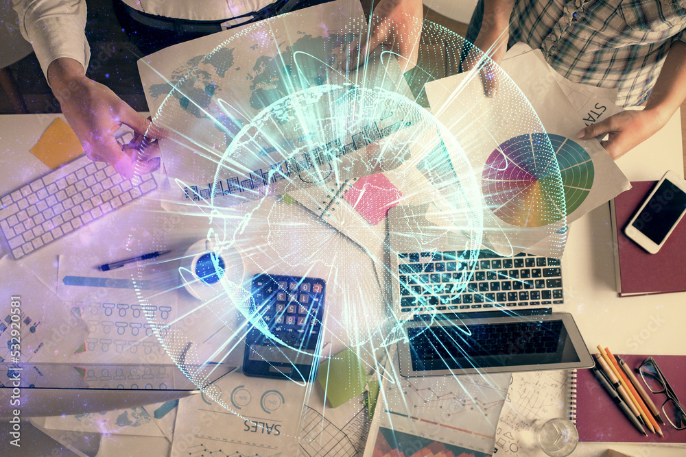 Double exposure of man and woman working together and business theme hologram drawing. Computer background. Top View. Double exposure of man and woman working together and business theme hologram drawing. Computer background. Top View.