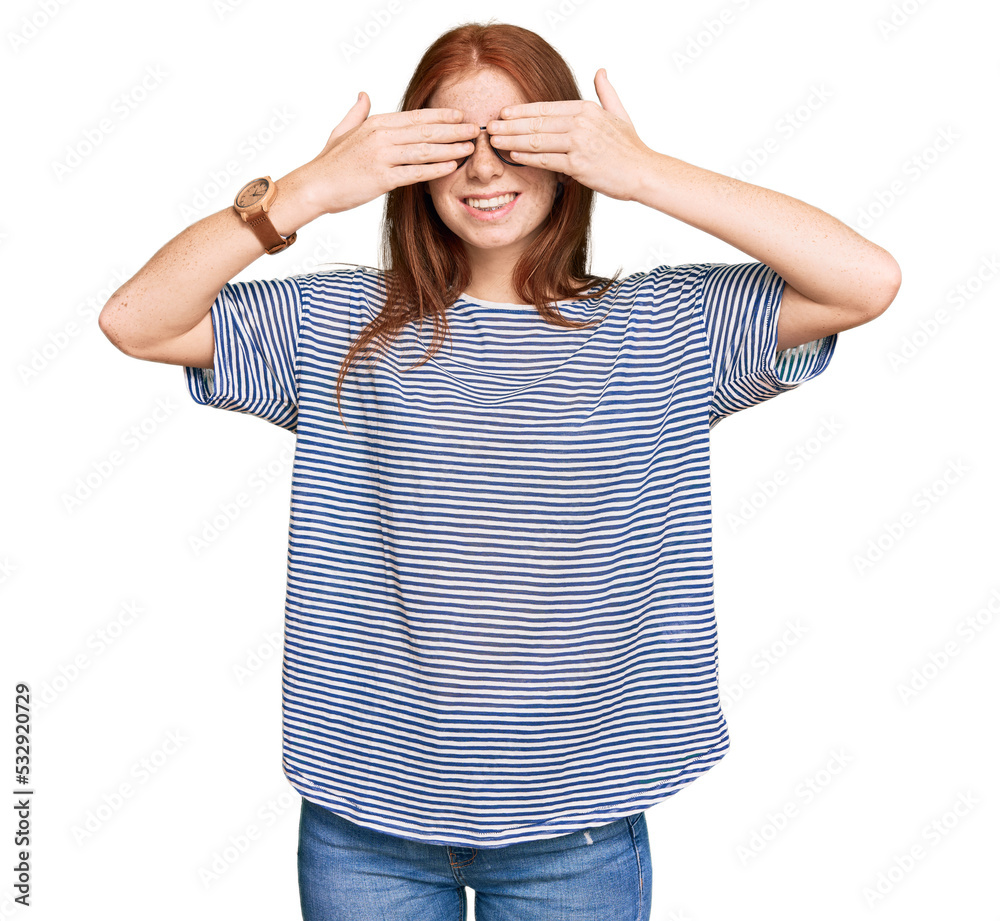 Young read head woman wearing casual clothes and glasses covering eyes with hands smiling cheerful and funny. blind concept. Young read head woman wearing casual clothes and glasses covering eyes with hands smiling cheerful and funny. blind concept.